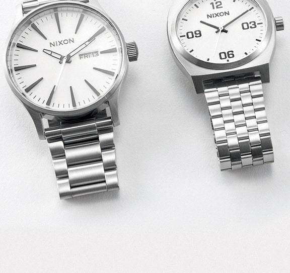 Two Nixon wedding gift watches in silver and white